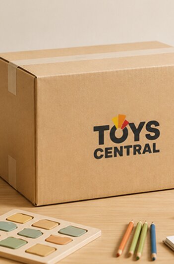 A ToysCentral branded shipping box surrounded by toys and art supplies
